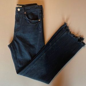 Black straight leg jeans with a raw hem